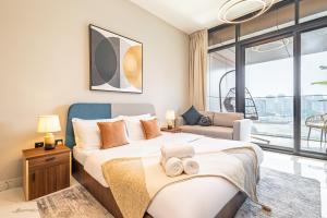 a bedroom with a large bed and a couch at Charming Studio - Full Canal Views - 5 min walk from ADGM, Cleveland and Galleria - Perfect for Corporate Travelers - Big Balcony - Heart of Maryah Island in Abu Dhabi
