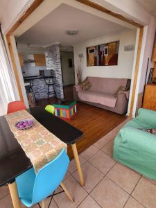 a living room with a table and a couch at Alojamiento Costazul2 in Iquique