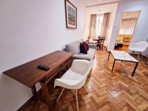 a living room with a table and a couch at SUH Copacabana 19 Spacious Near The Beach! in Rio de Janeiro +15 photos