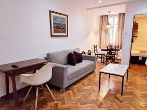 a living room with a couch and a table at SUH Copacabana 19 Spacious Near The Beach! in Rio de Janeiro