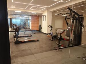 a gym with several tread machines in a room at Nuevo departamento de lujo céntrico Zona Obrajes in La Paz