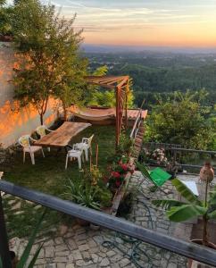 a view of a garden with a table and chairs at Ca' Parodi Bel View in Parodi Ligure +9 photos