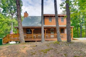 a log home with a large deck in the woods at Hot Tub and Deck! Bear Hugs Cabin Near Gatlinburg in Glade