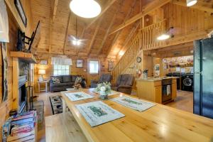a kitchen and living room with a table in a cabin at Hot Tub and Deck! Bear Hugs Cabin Near Gatlinburg in Glade