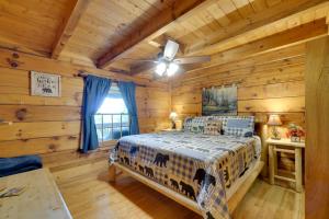 a bedroom with a bed in a log cabin at Hot Tub and Deck! Bear Hugs Cabin Near Gatlinburg in Glade