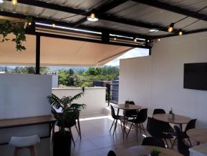 a restaurant with tables and chairs and a large window at Hotel Med Llanogrande in Rionegro