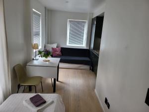 a small living room with a couch and a table at Apartment - Sleeps 3 & Great Location in Sollentuna
