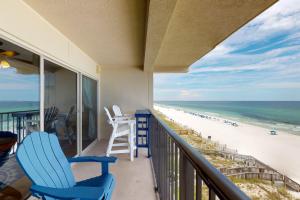 a balcony with chairs and a view of the beach at Emerald Towers West 5001 in Fort Walton Beach