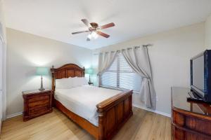 a bedroom with a bed and a ceiling fan at Emerald Towers West 5001 in Fort Walton Beach +18 photos