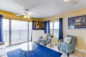 a living room with a glass table and chairs at Emerald Towers West 5007 in Fort Walton Beach