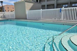 a swimming pool with blue water in front of a building at Emerald Towers West 5007 in Fort Walton Beach
