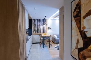 a small apartment with a kitchen and a small table at BiancaNeve Jahorina in Jahorina