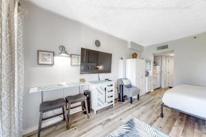 Un dormitorio con una cama y un escritorio con una computadora. en Pirates Bay B102, en Fort Walton Beach