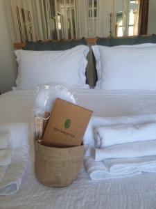 a hotel room with a bed with towels and a box on it at Bracciera Lipsi Apts 2 in Lipsoi