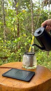 a person is pouring liquid into a glass jar at Silvery Bungalows en el Bosque in San Carlos +46 photos