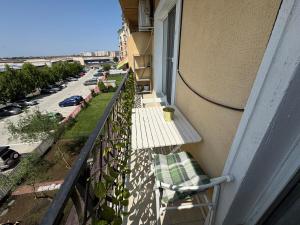 a balcony with a bench and a view of a street at Blue Oasis in Ştefăneştii de Sus