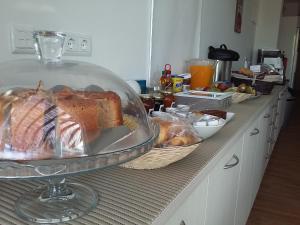 a counter with bread and other food on it at Tavira Monte in Tavira
