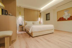 a hotel room with a bed and a table at Eternity Athens in Athens