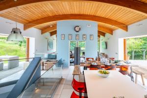 a kitchen with blue walls and a wooden ceiling at Sedum House in Gimingham