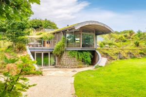 an exterior view of a house with a large window at Sedum House 8 in Gimingham