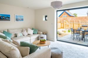 a living room with a couch and a table at Neathercoat in Wells next the Sea