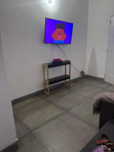 a room with a table and a tv on a wall at El Descanso in Posadas