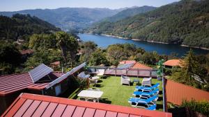a house with chairs and a view of a lake at Casa do Lagar in Geres