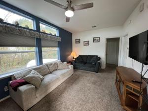 a living room with a couch and a television at 3-bedroom house Rockaway Beach in Rockaway Beach