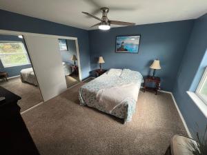 a bedroom with a bed and a ceiling fan at 3-bedroom house Rockaway Beach in Rockaway Beach
