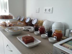 a counter topped with bowls and plates of food at Tavira Monte in Tavira