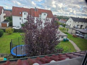 a tree in front of a house with a basketball hoop at S&P Dream Apartment in Backnang