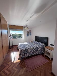 a bedroom with a bed and a window at Alojamiento Ines in Sanxenxo