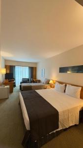 Ένα ή περισσότερα κρεβάτια σε δωμάτιο στο Alphaville Hotel e Residence 1503
