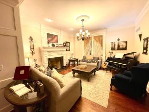 a living room with a couch and a piano at Temple View Inn with Music Studio in Independence