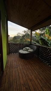 a large tire sitting on a wooden deck at Chalé Encanto da Serra in São Francisco Xavier