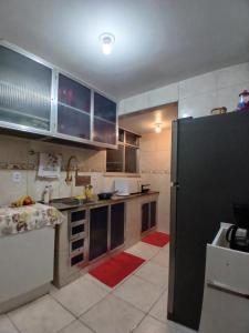 a kitchen with a black refrigerator in a room at indisponivel in Niterói