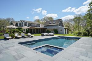 a swimming pool in the backyard of a house at Luxe Chilmark EstatePool, BBQ & Pvt Quansoo Beach in West Tisbury