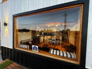a store window with a view of a living room at Cabañas Los Manzanos in Cholila