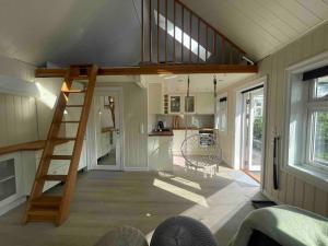 a tiny house with a staircase in a kitchen at Holiday apartment in Jessheim in Jessheim