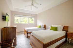 a bedroom with two beds and a window at Uvita Paradise , Walk to the Ballena Beach in Uvita +91 photos