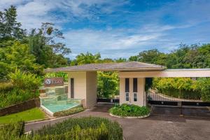 a house with a swimming pool in the driveway at Uvita Paradise , Walk to the Ballena Beach in Uvita