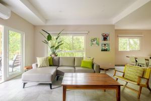 a living room with a couch and a coffee table at Uvita Paradise , Walk to the Ballena Beach in Uvita