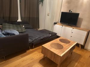 a living room with a couch and a coffee table at The Cozy Double Retreat in London
