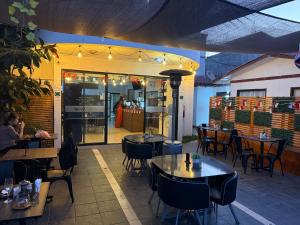 a restaurant with tables and chairs in front of it at Hotel Cecil in Vallenar