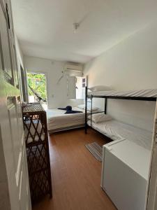 a small room with two bunk beds in it at TiaPreta Pousada in Cayru