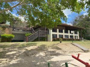 a building with a ramp in front of it at Flat superior no Monte Castelo Condomínio in Gravatá