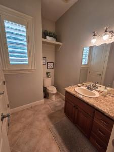 a bathroom with a sink and a toilet at Chefs Kitchen Theater Sauna Game Room PDX in Happy Valley +36 photos