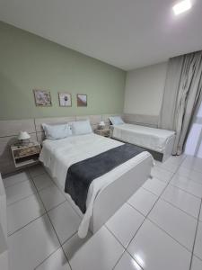 Ένα ή περισσότερα κρεβάτια σε δωμάτιο στο Residencial New Stilo-Falésia