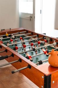 a billiard table with a group of dolls on it at Casa do Outeiro in São Bartolomeu do Outeiro