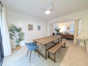 a dining room with a table and a blue chair at FL1 House NEW Miami Oasis Game Room & Firepit in Tamiami